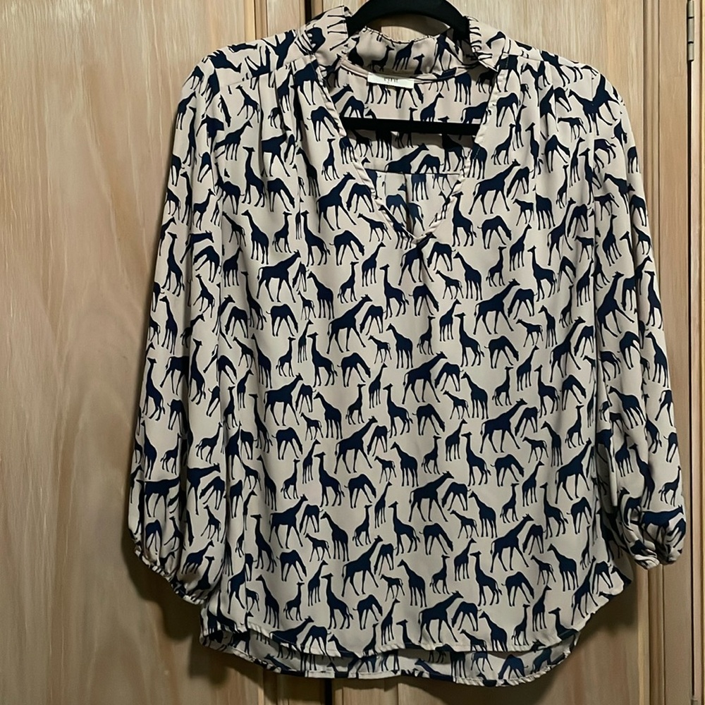 Small Ezra tan blouse with blue giraffes.